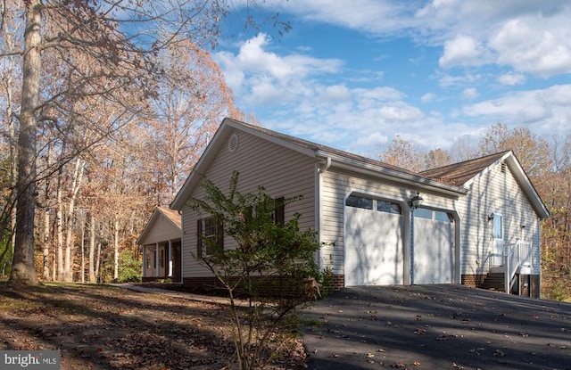 view of side of home featuring a garage