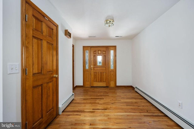 entryway with light wood-type flooring and baseboard heating