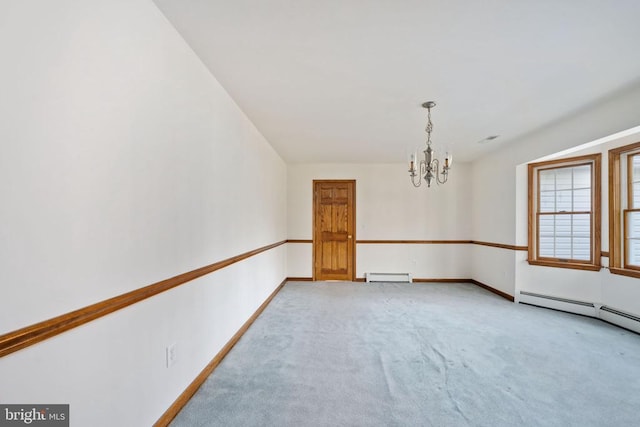 empty room featuring a baseboard heating unit, a chandelier, and light carpet