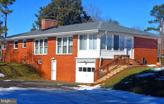 view of snowy exterior with a garage