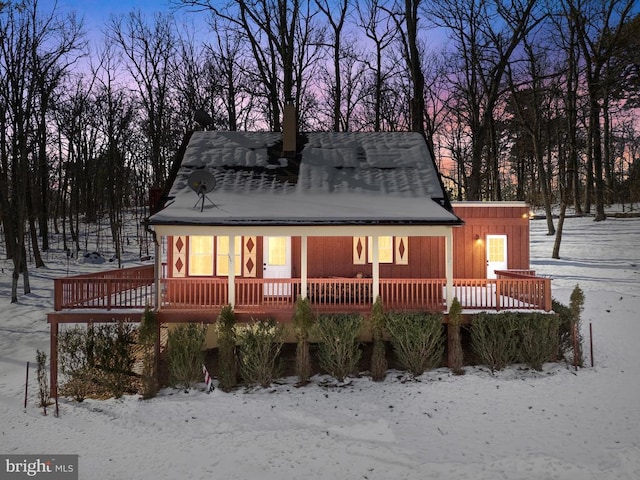 snow covered house with a deck