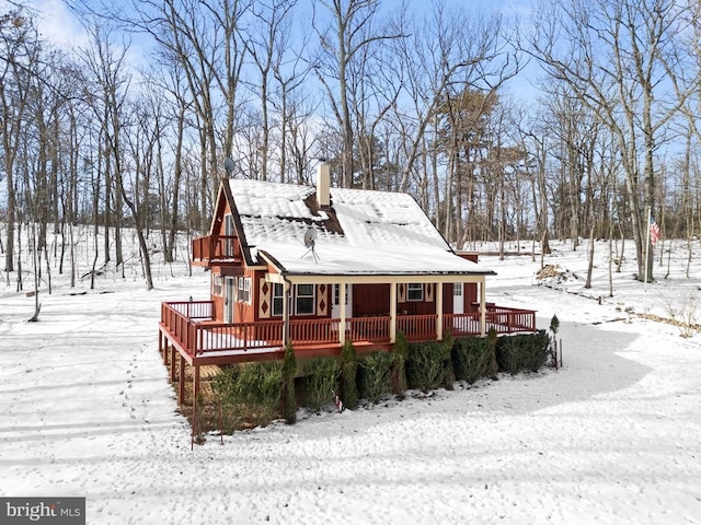 snow covered house with a deck