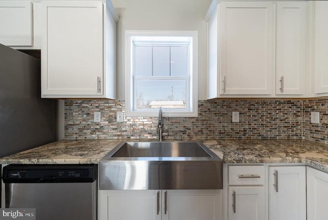 kitchen featuring stainless steel dishwasher, tasteful backsplash, and white cabinetry