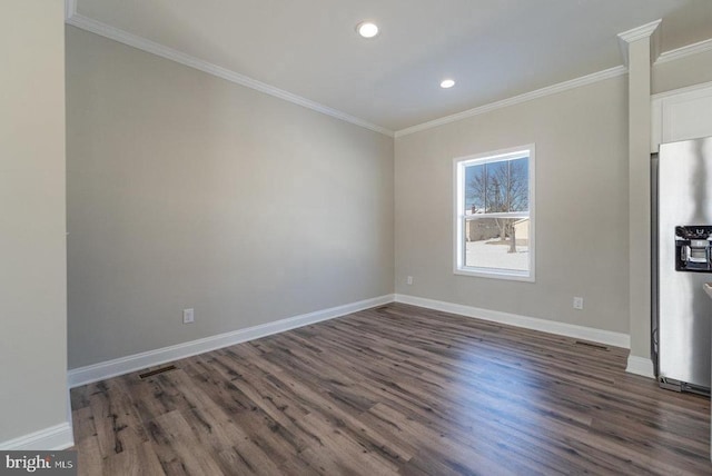 spare room with dark hardwood / wood-style floors and crown molding