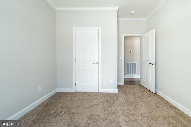 unfurnished bedroom featuring light carpet and ornamental molding