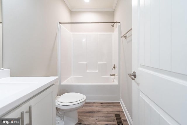 full bathroom with tub / shower combination, vanity, toilet, hardwood / wood-style flooring, and crown molding