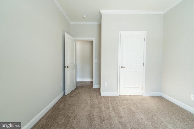 unfurnished bedroom featuring ornamental molding and carpet floors