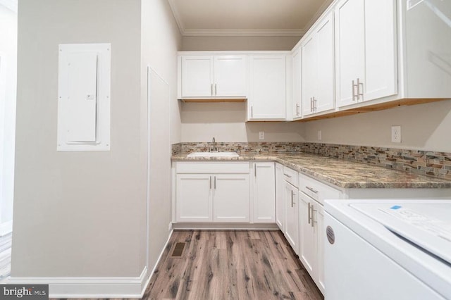 kitchen featuring white cabinetry and ornamental molding