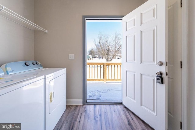 washroom with wood-type flooring and washer and dryer