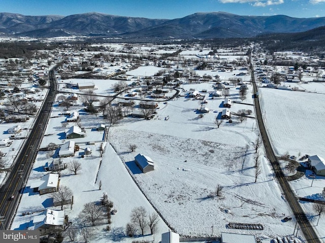 snowy aerial view featuring a mountain view