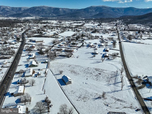 snowy aerial view with a mountain view