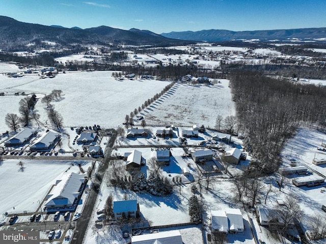 snowy aerial view with a mountain view