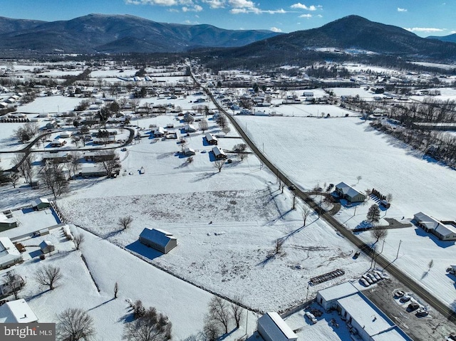 snowy aerial view featuring a mountain view