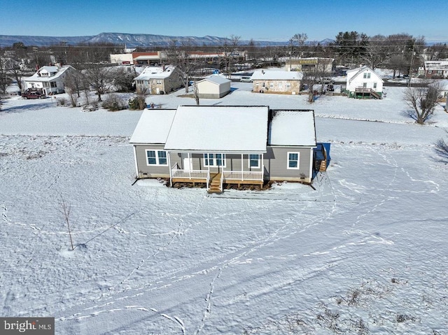 snowy aerial view with a mountain view