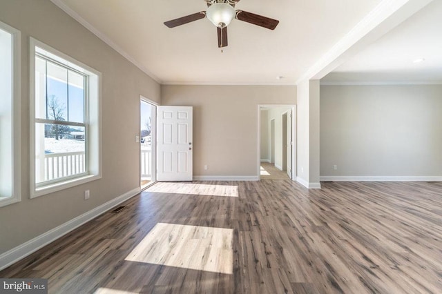 interior space with ceiling fan, dark hardwood / wood-style floors, and crown molding