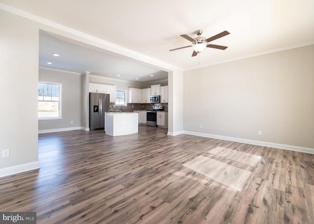 unfurnished living room with ceiling fan, wood-type flooring, and ornamental molding