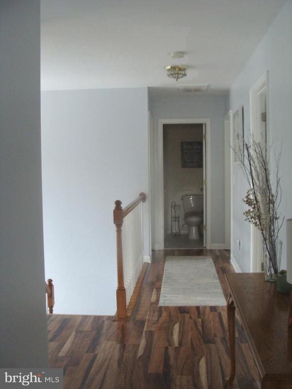 hall with dark wood-type flooring