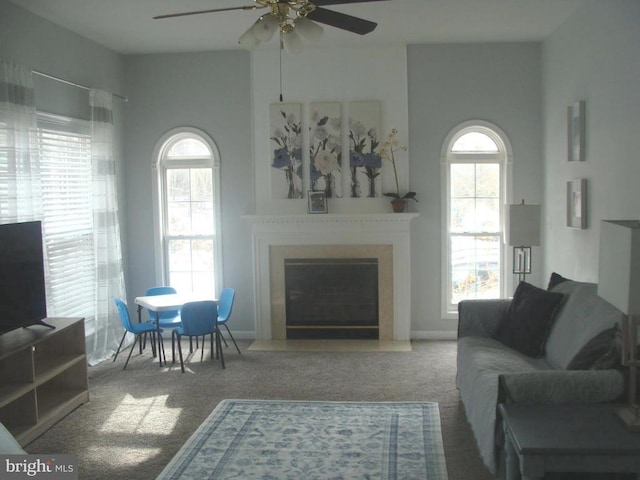 living room featuring ceiling fan and carpet