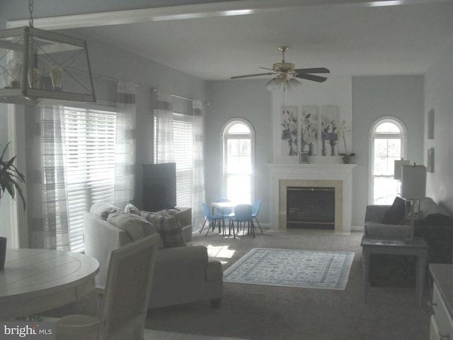 living room with ceiling fan and carpet floors