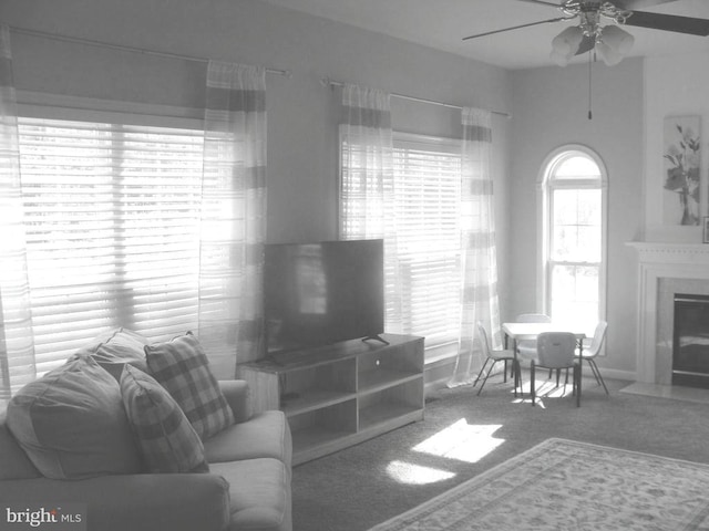 living room with plenty of natural light, carpet floors, and ceiling fan