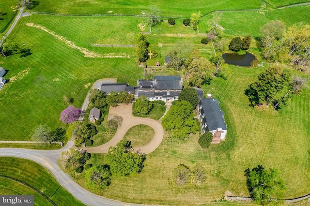 drone / aerial view with a water view and a rural view