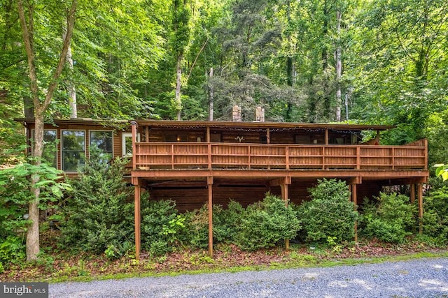 rear view of house featuring a deck