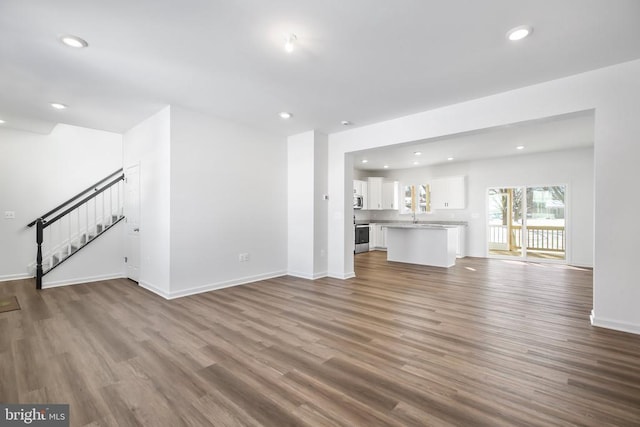 unfurnished living room with dark hardwood / wood-style flooring