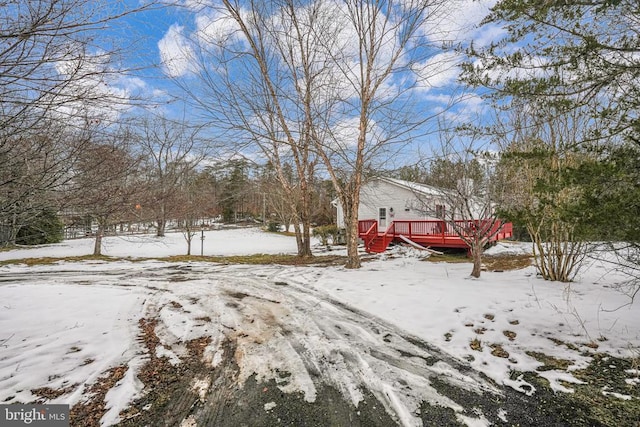 snowy yard with a wooden deck