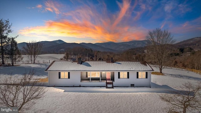 snow covered house with a mountain view