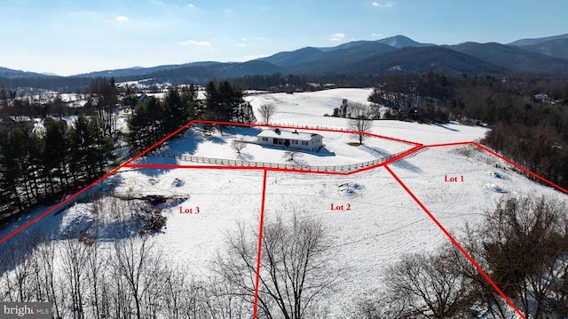 snowy aerial view featuring a mountain view