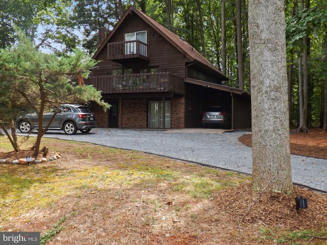 view of front of property with a carport and a balcony