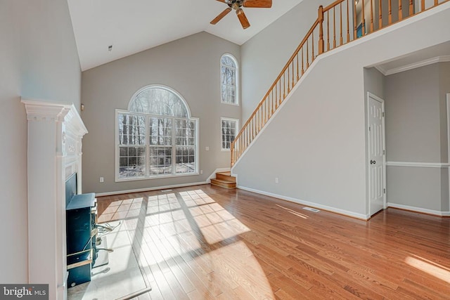 unfurnished living room featuring ceiling fan, hardwood / wood-style floors, and high vaulted ceiling