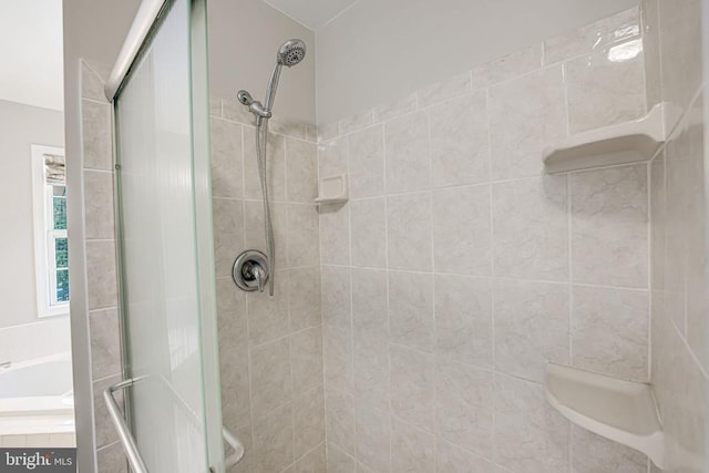 bathroom with shower with separate bathtub