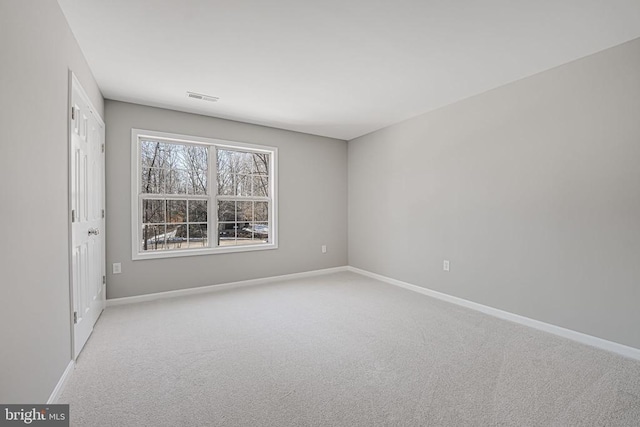 unfurnished room with light colored carpet