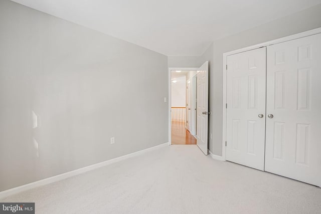 unfurnished bedroom featuring carpet floors and a closet