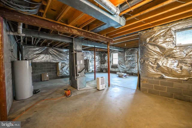 basement with water heater, a wealth of natural light, and heating unit