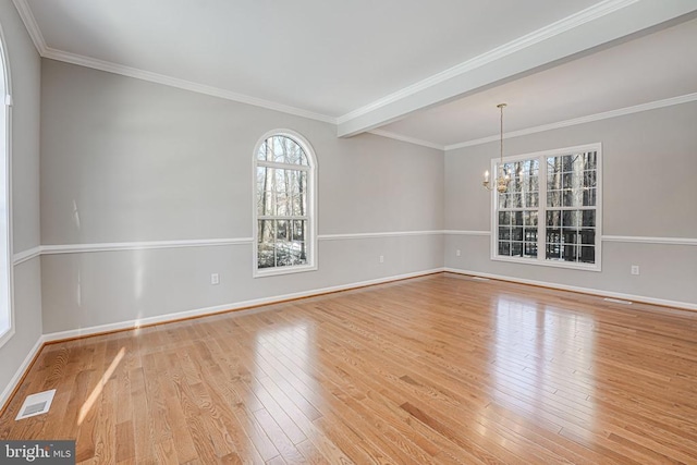 unfurnished room with crown molding, light hardwood / wood-style floors, and a notable chandelier