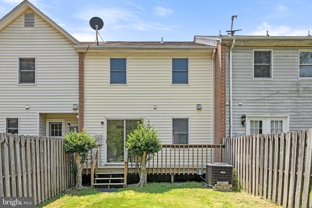 rear view of property featuring a wooden deck and central air condition unit