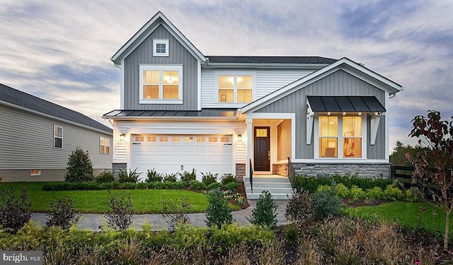 craftsman-style home featuring a garage and a front yard