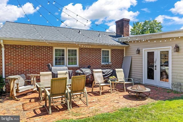 view of patio featuring french doors and an outdoor fire pit