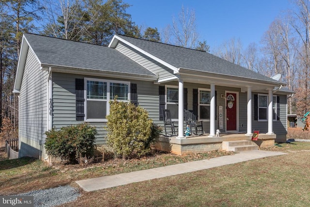 view of front of house with a porch and a front lawn