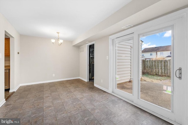 empty room featuring an inviting chandelier