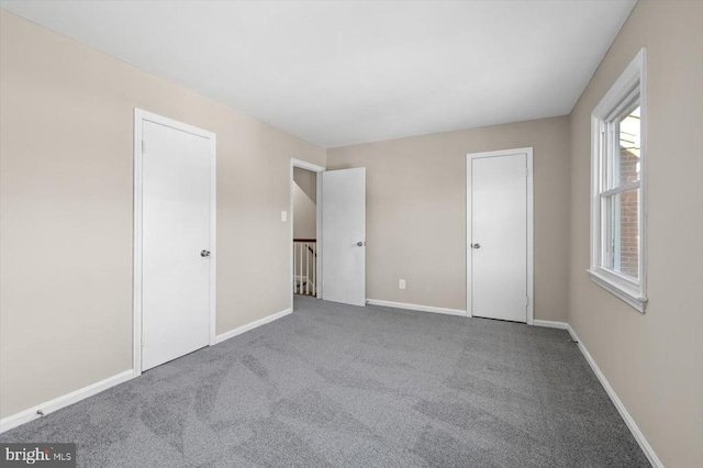 unfurnished bedroom featuring light carpet