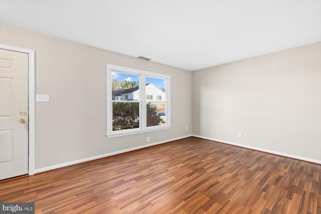 empty room with hardwood / wood-style flooring