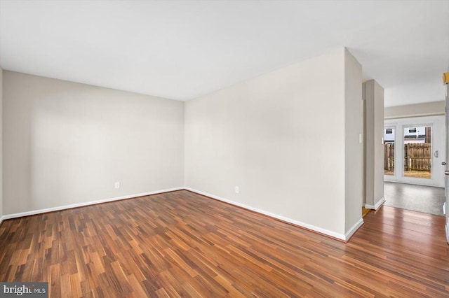 spare room with dark wood-type flooring