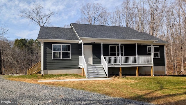 view of front of property with a front yard and covered porch