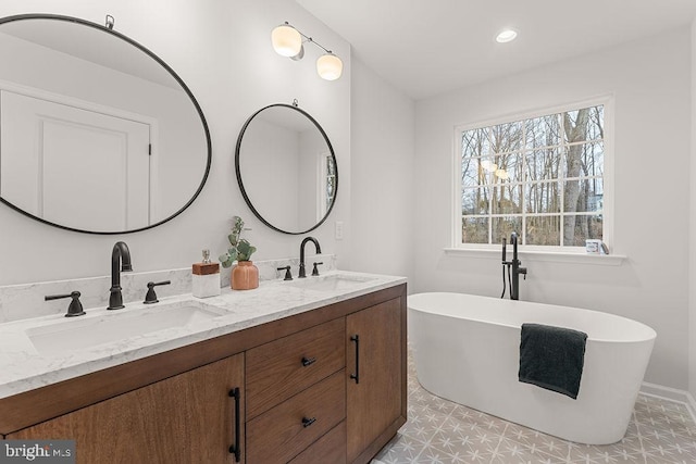 bathroom featuring vanity and a tub to relax in