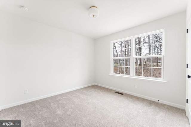 unfurnished room featuring carpet