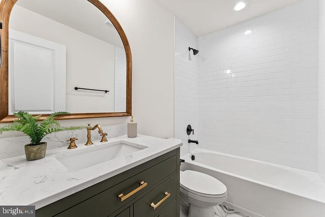 full bathroom featuring vanity, toilet, and tiled shower / bath