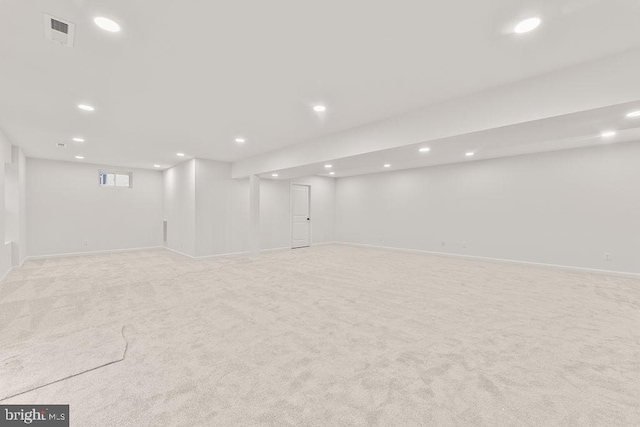 basement featuring light colored carpet